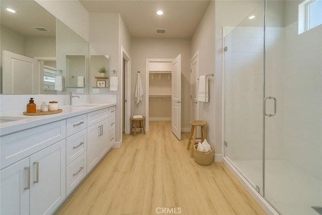 67813 Rio Vista Dr, Cathedral City, CA 92234 - full bath with wood finished floors, double vanity, a stall shower, a spacious closet, and recessed lighting