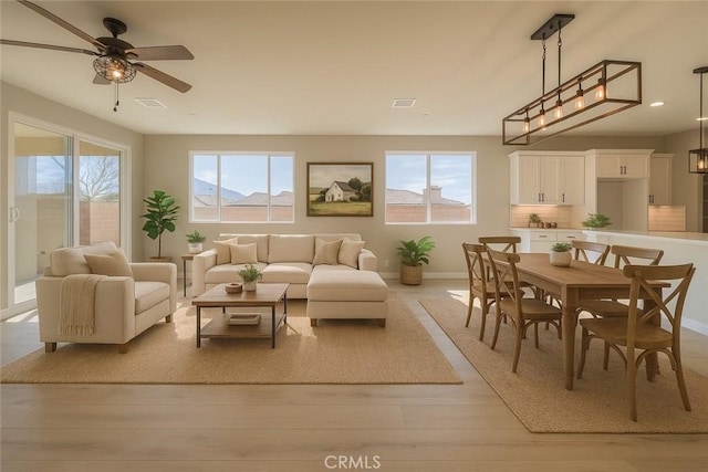 67813 Rio Vista Dr, Cathedral City, CA 92234 - living area featuring plenty of natural light, ceiling fan, and light wood-style floors