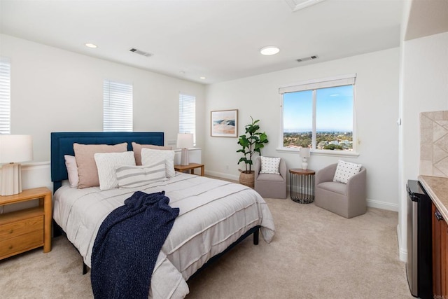 bedroom featuring beverage cooler, light colored carpet, visible vents, and baseboards