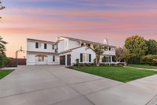 view of front facade featuring an attached garage, stucco siding, concrete driveway, and a front yard