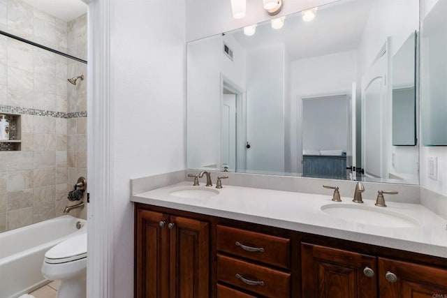 full bathroom with toilet, visible vents, a sink, and shower / bathtub combination