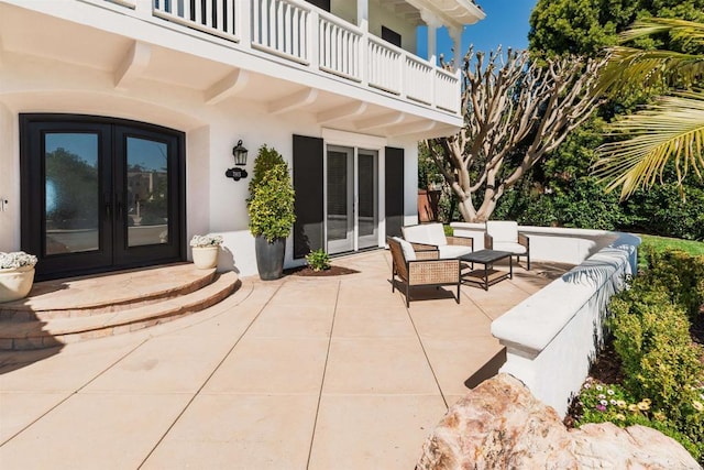 view of patio / terrace with french doors and a balcony