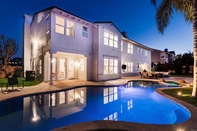 view of swimming pool with a pool with connected hot tub and a patio