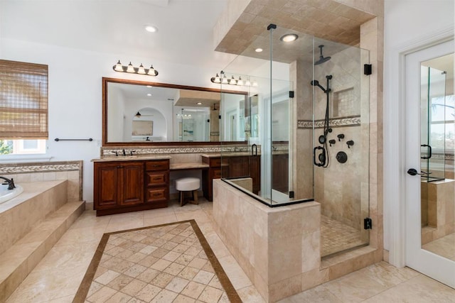 full bathroom with a garden tub, a shower stall, plenty of natural light, and vanity