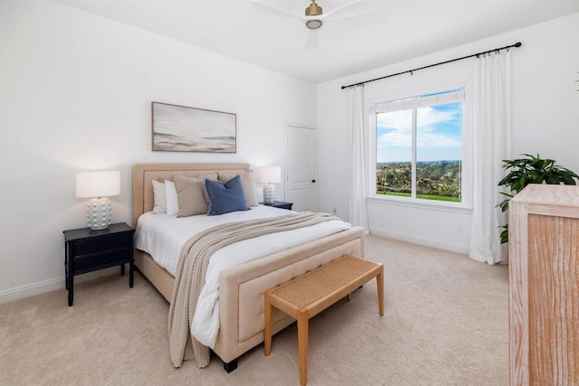 bedroom featuring light carpet, ceiling fan, and baseboards