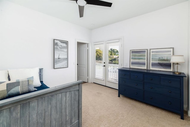 bedroom featuring access to exterior, french doors, a ceiling fan, and light colored carpet