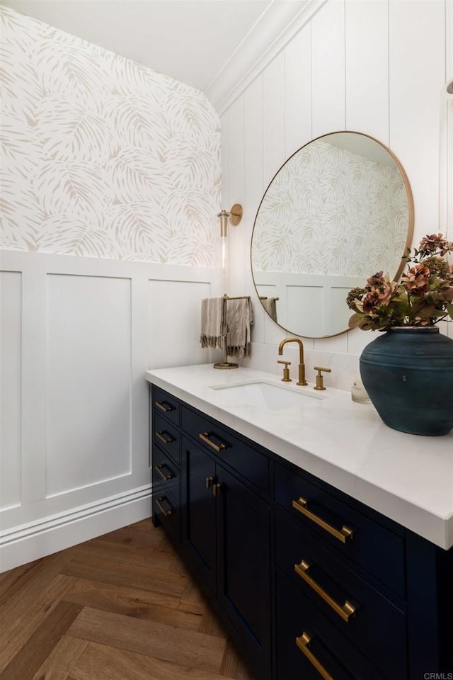 bathroom featuring a decorative wall and vanity