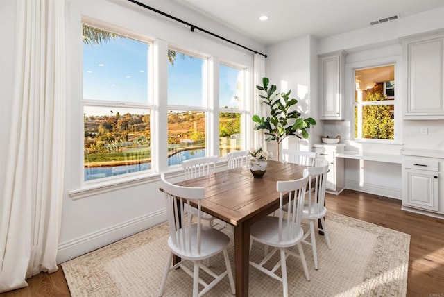 dining area with plenty of natural light, visible vents, dark wood-style flooring, and recessed lighting