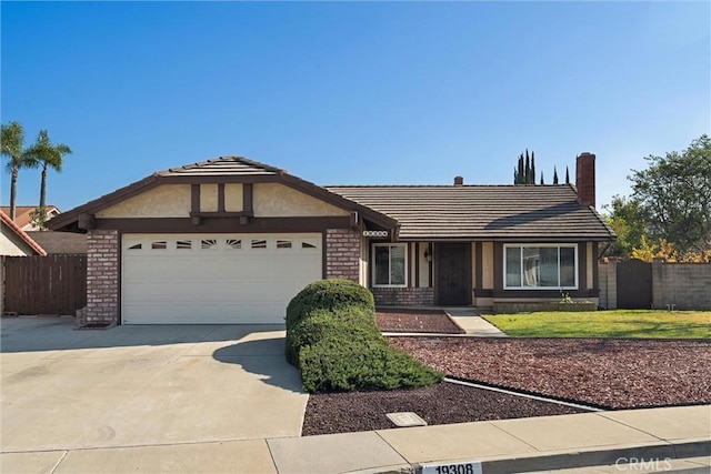 ranch-style house with a garage, fence, concrete driveway, and brick siding