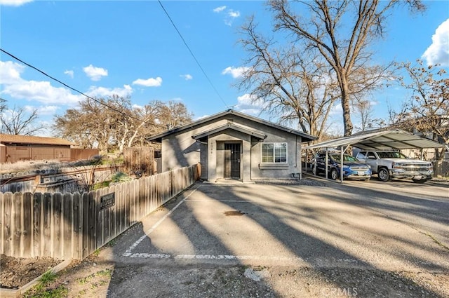 view of front of property with fence and a detached carport