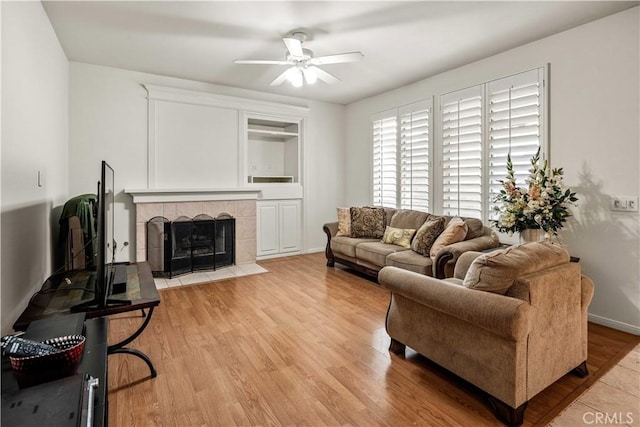 23718 Hathaway Dr, Valencia, CA 91354 - living room featuring a ceiling fan, light wood-style flooring, and a fireplace