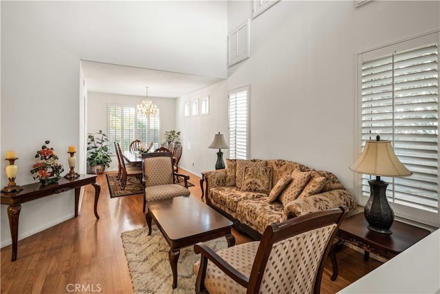 23718 Hathaway Dr, Valencia, CA 91354 - living room with a chandelier, wood finished floors, and baseboards