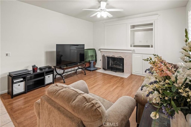 23718 Hathaway Dr, Valencia, CA 91354 - living room with ceiling fan, a fireplace, light wood finished floors, and baseboards