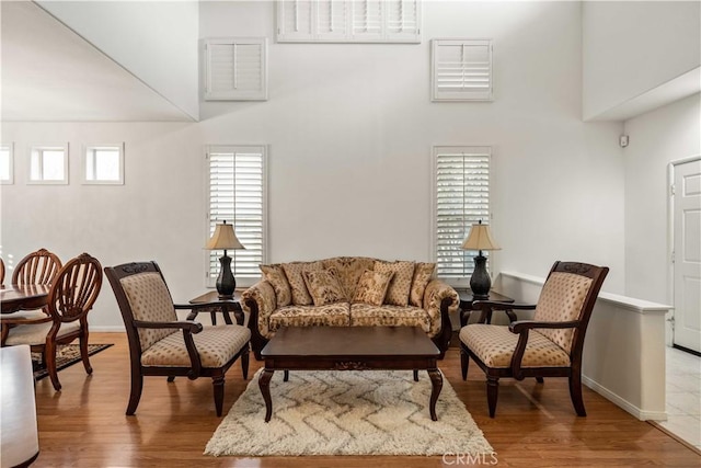 23718 Hathaway Dr, Valencia, CA 91354 - living area with a high ceiling, wood finished floors, and baseboards