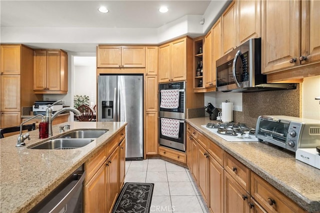 23718 Hathaway Dr, Valencia, CA 91354 - kitchen featuring appliances with stainless steel finishes, a sink, light stone countertops, light tile patterned floors, and recessed lighting