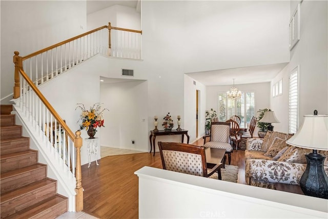 23718 Hathaway Dr, Valencia, CA 91354 - living room with stairs, a chandelier, wood finished floors, and a towering ceiling