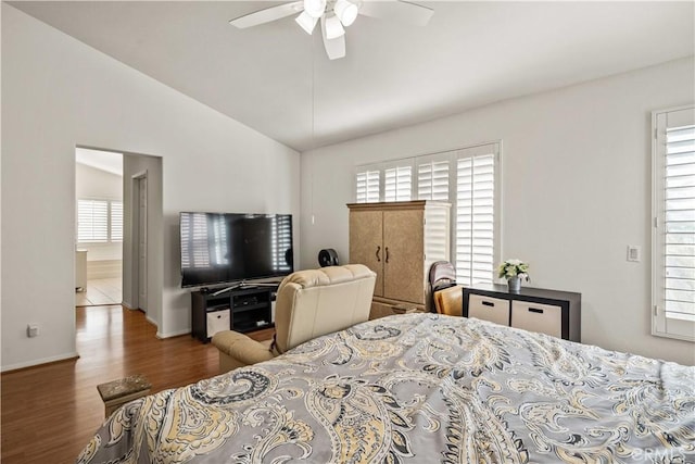 23718 Hathaway Dr, Valencia, CA 91354 - bedroom with multiple windows, wood finished floors, vaulted ceiling, baseboards, and a ceiling fan