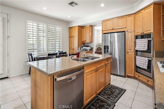 23718 Hathaway Dr, Valencia, CA 91354 - kitchen featuring appliances with stainless steel finishes, a sink, light tile patterned floors, light stone countertops, and recessed lighting