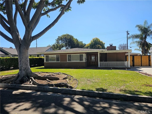 single story home with concrete driveway, a chimney, a front yard, and stucco siding