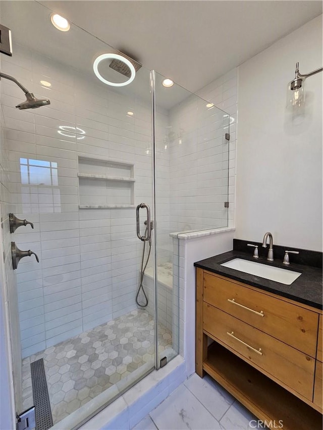 full bathroom featuring a shower stall, vanity, and recessed lighting