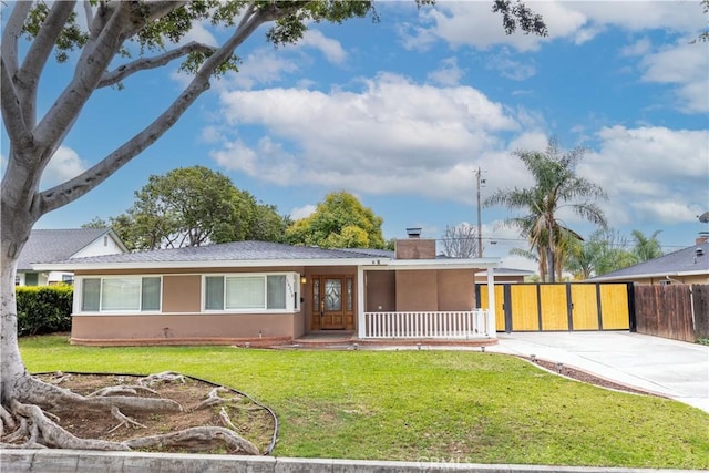 single story home featuring stucco siding, driveway, fence, a front yard, and a chimney