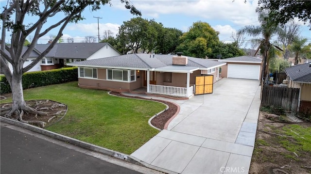 ranch-style home featuring a front lawn, fence, covered porch, an outdoor structure, and a chimney