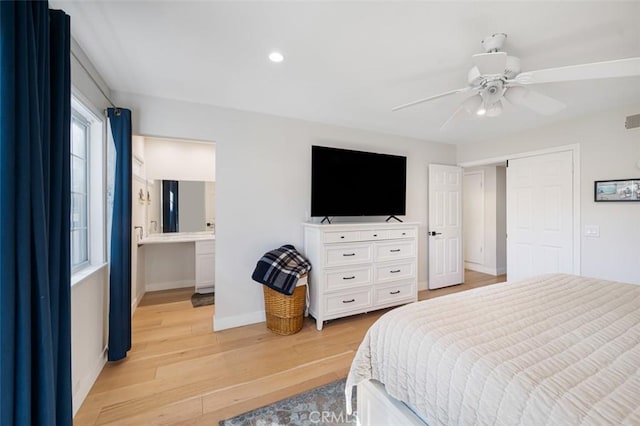 bedroom with visible vents, baseboards, a ceiling fan, connected bathroom, and light wood-style flooring