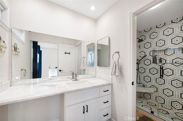 full bathroom featuring recessed lighting, a shower stall, and vanity