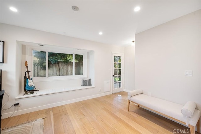 sitting room featuring baseboards, wood finished floors, and recessed lighting