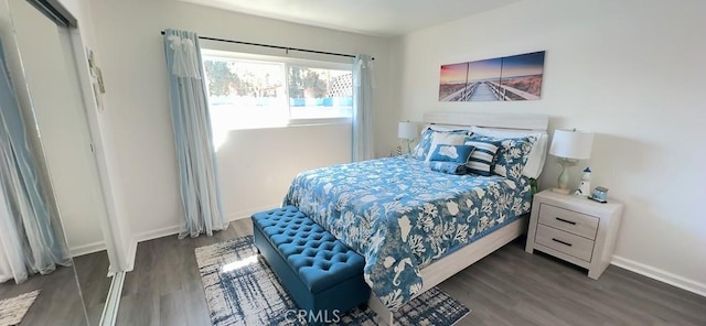 bedroom featuring dark wood-style floors and baseboards