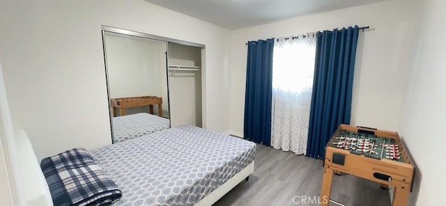 bedroom featuring a closet and wood finished floors