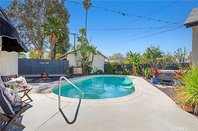 view of swimming pool featuring a fenced in pool, a fenced backyard, and a patio