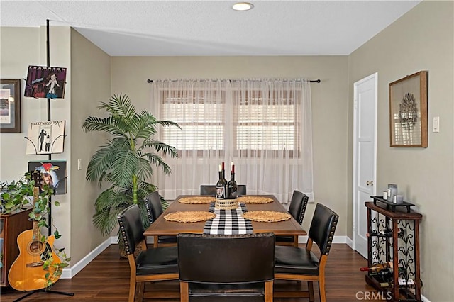 dining room featuring baseboards and wood finished floors