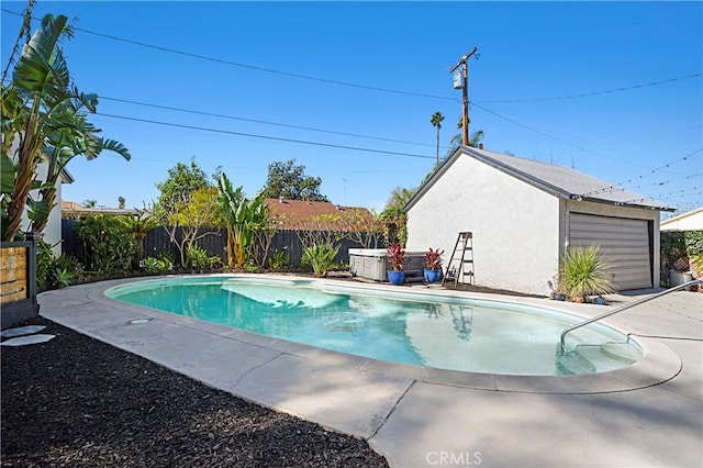 view of swimming pool featuring an outbuilding, a fenced backyard, and a fenced in pool