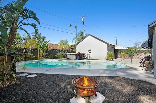 view of swimming pool featuring a patio area, a fenced backyard, a fenced in pool, and an outbuilding