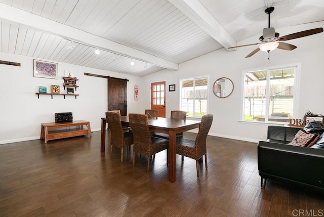 dining space featuring dark wood-style floors, vaulted ceiling with beams, a barn door, ceiling fan, and baseboards