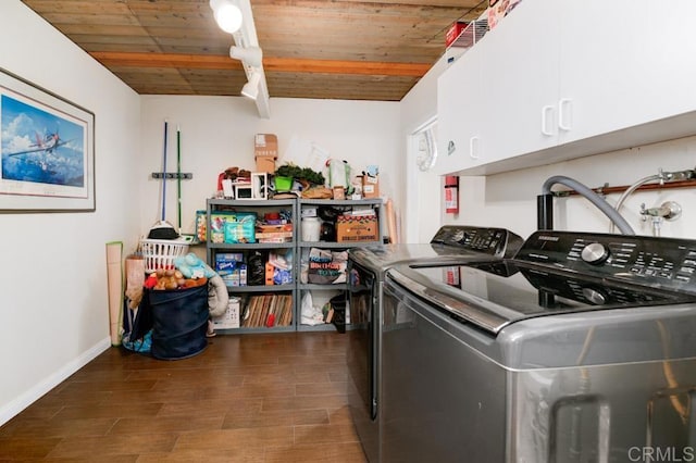 washroom with cabinet space, baseboards, wooden ceiling, dark wood-style floors, and separate washer and dryer