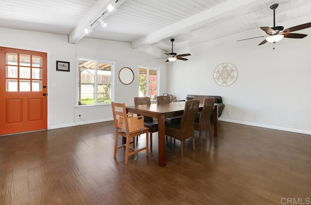 dining area featuring dark wood-style flooring, vaulted ceiling with beams, rail lighting, wood ceiling, and baseboards