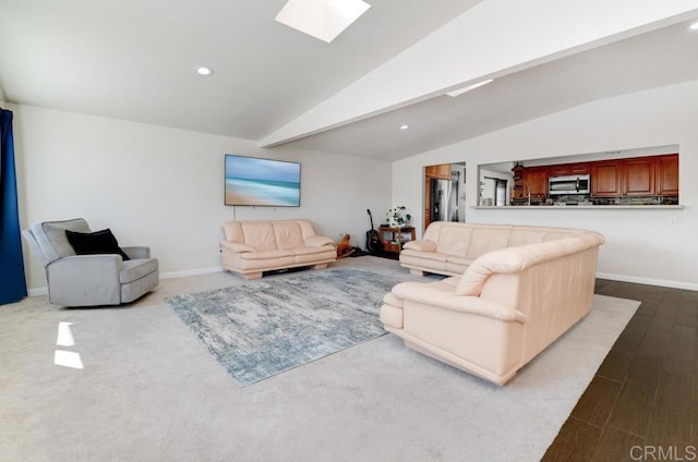 living area with vaulted ceiling with skylight, baseboards, and recessed lighting