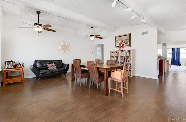 dining area with dark wood-style flooring, visible vents, vaulted ceiling with beams, and baseboards