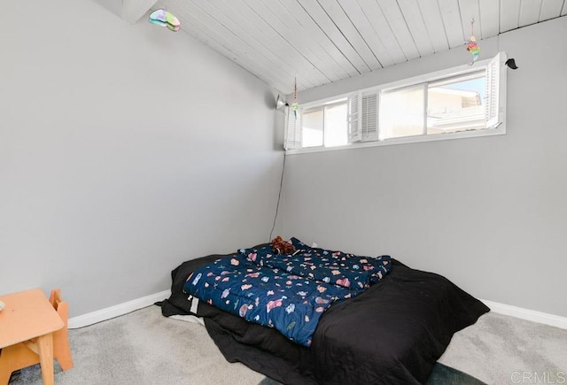 bedroom featuring vaulted ceiling, carpet flooring, wood ceiling, and baseboards