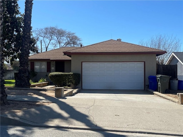 single story home with driveway, a shingled roof, a garage, and stucco siding