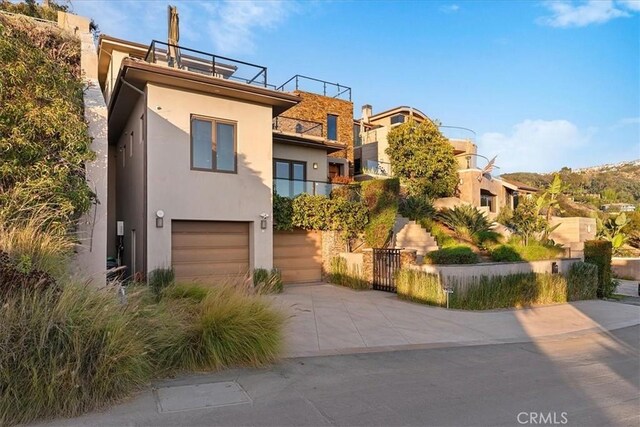 31422 Ceanothus Dr, Laguna Beach, CA 92651 - view of front of house with stucco siding, driveway, an attached garage, and a gate