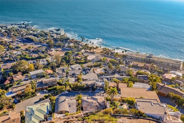 aerial view featuring a beach view, a water view, and a residential view