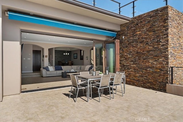 view of patio / terrace featuring outdoor dining space and an outdoor living space