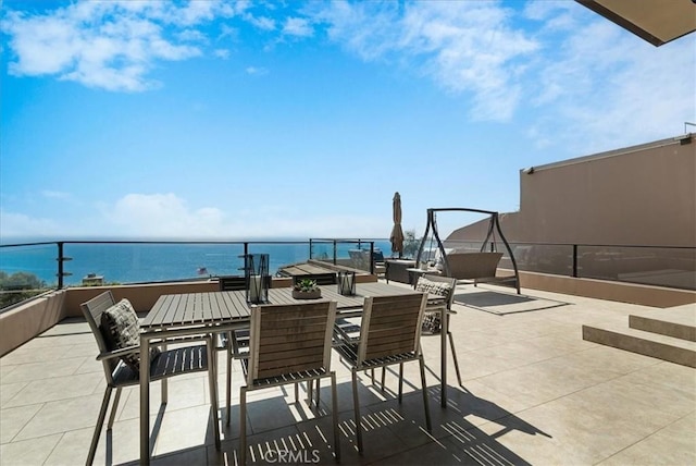 view of patio featuring outdoor dining space and a water view