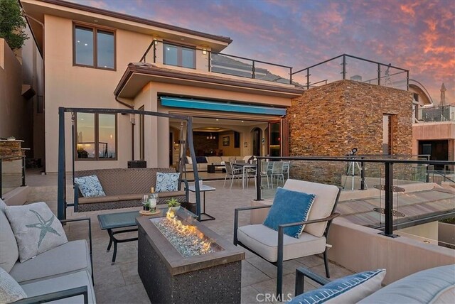 31422 Ceanothus Dr, Laguna Beach, CA 92651 - back of property featuring an outdoor living space with a fire pit, stucco siding, and a patio
