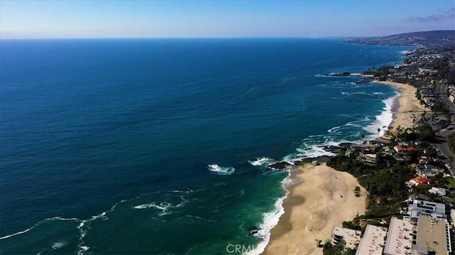 drone / aerial view with a beach view and a water view