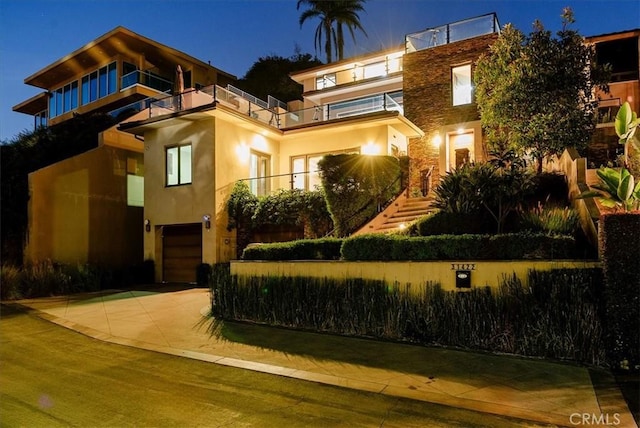 31422 Ceanothus Dr, Laguna Beach, CA 92651 - view of front facade with a balcony, stucco siding, concrete driveway, and a garage