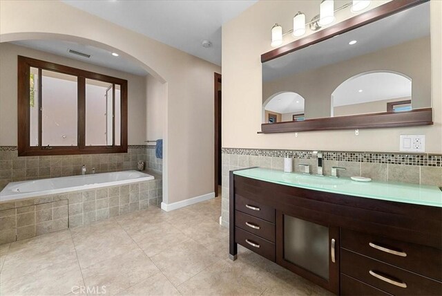 31422 Ceanothus Dr, Laguna Beach, CA 92651 - bathroom featuring vanity, tile patterned floors, a bath, tile walls, and a wainscoted wall